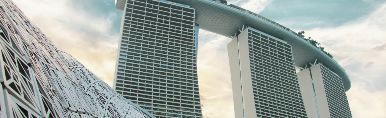 A tall building with a clock on its facade, towering over the city skyline.