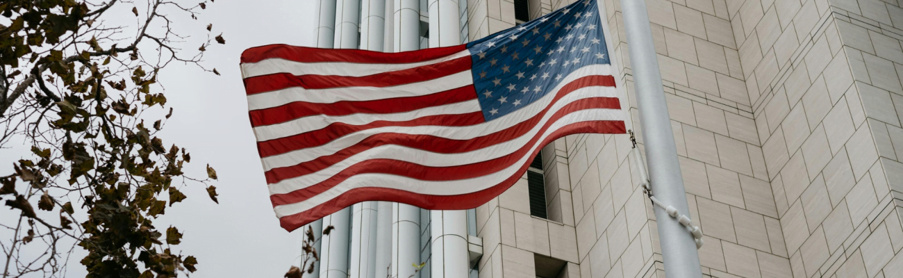 The American flag waving in front of a building.