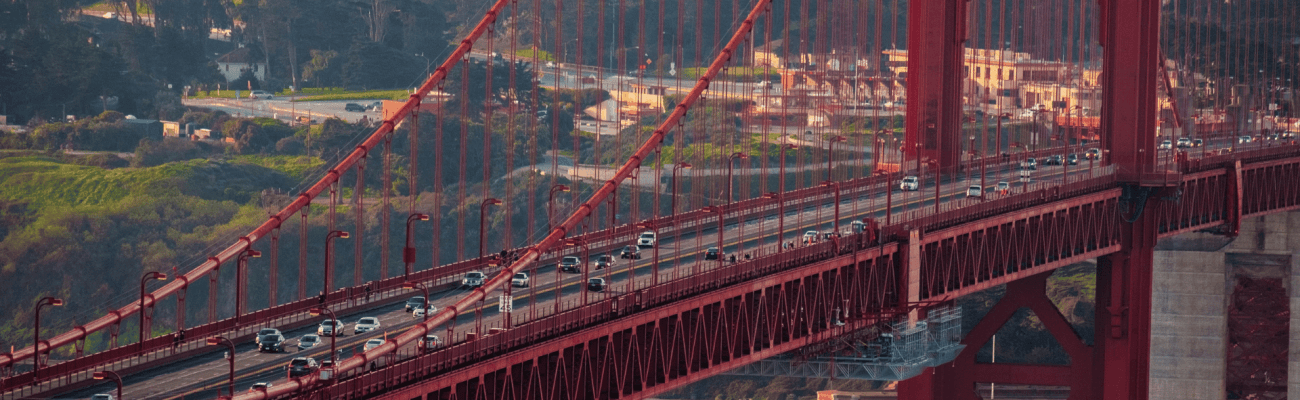 Golden Gate Bridge in San Francisco, showcasing its orange-red color against a clear blue sky.