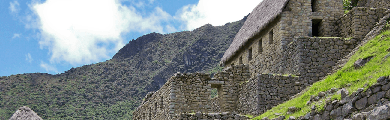 Ancient ruins of Machu Picchu nestled in the Andes, showcasing stunning stone structures and lush green surroundings.
