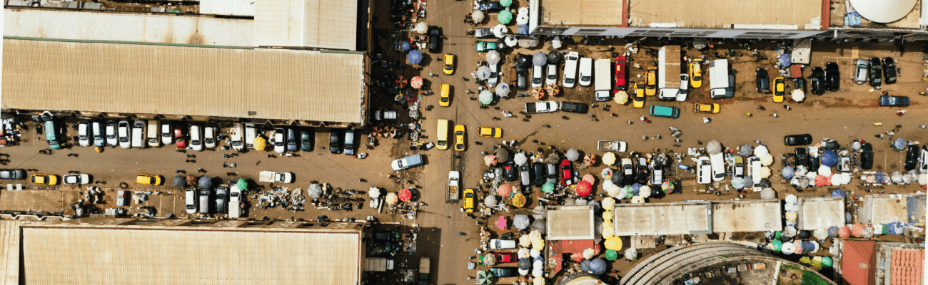 Bird's-eye view of a city street teeming with cars, highlighting the movement and activity within an urban environment.